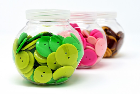 3 jars of coloured clothing buttons