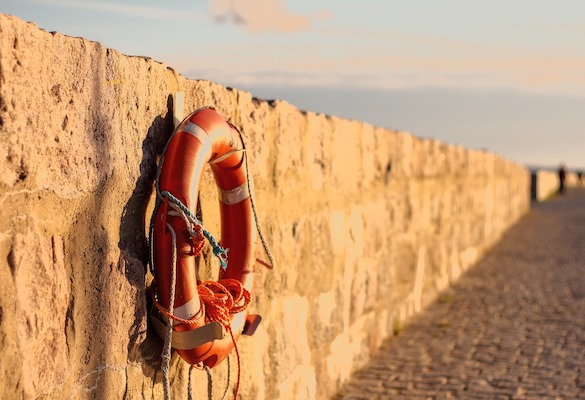 life ring hanging on harbour wall